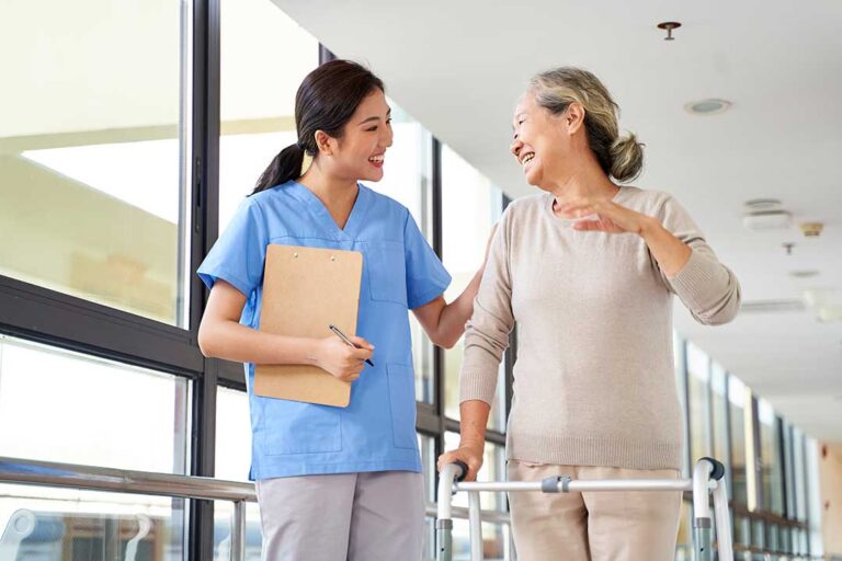 A senior resident personalizing her living space with family photos and favorite decorations.